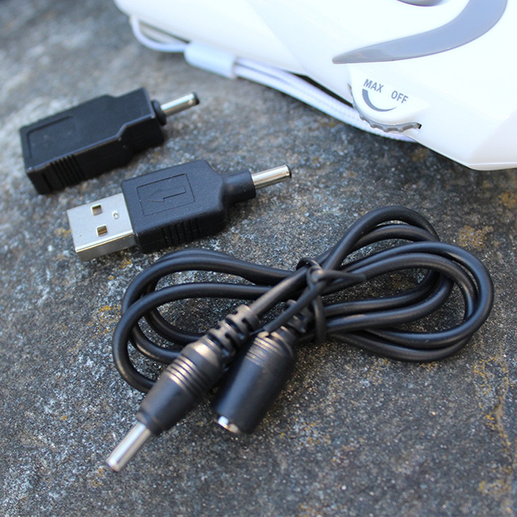 hand-crank light and radio with USB device charger adapter and wires